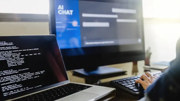 AI chat bot, Programmer using generative artificial intelligence for software development inside office.