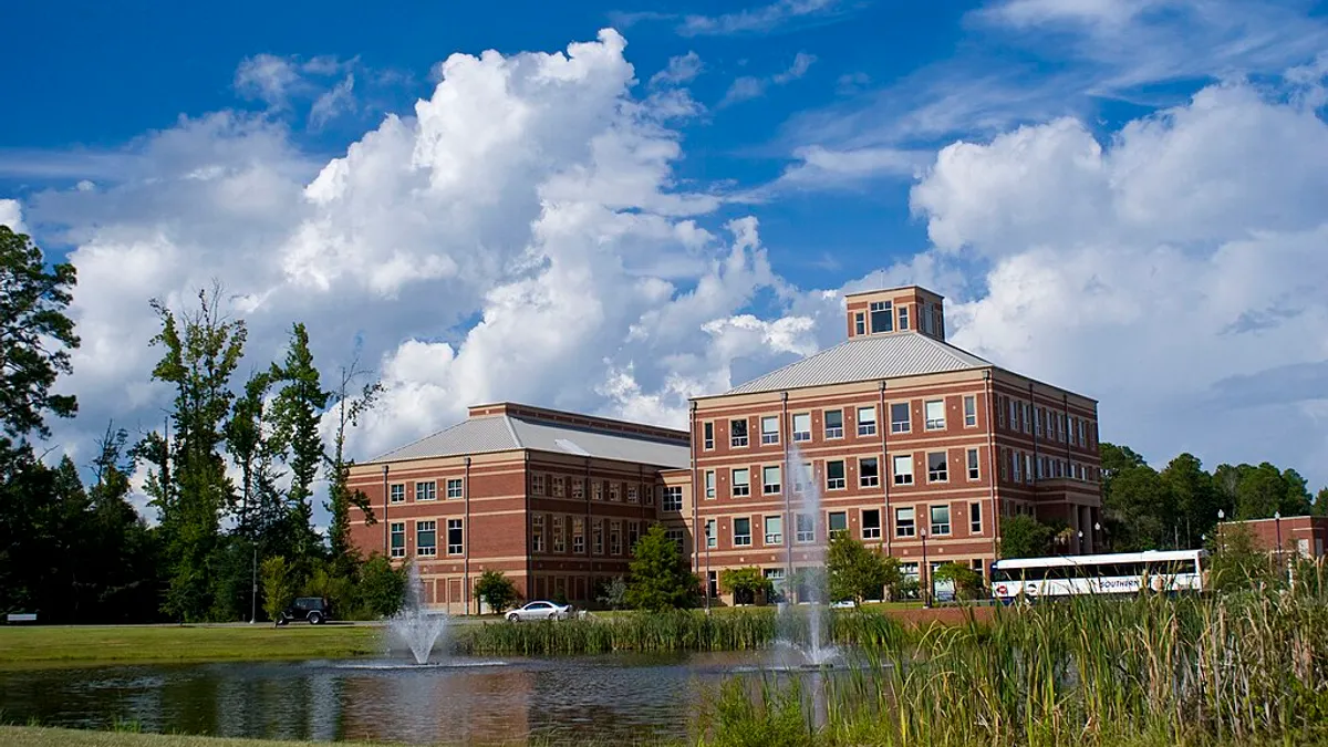 View of a brick building from across landscaping pond.